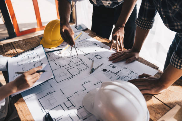 istock Architect concept, Architects working with blueprints in the office, Vintage Effect 1437928475