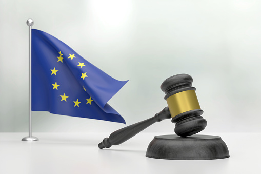 Black Wooden Gavel And European Union Flag On White Background. Justice Concept. Justice Concept.