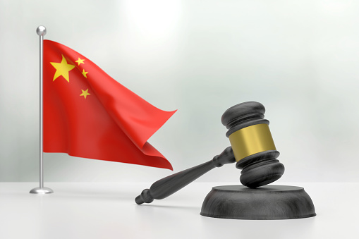 Black Wooden Gavel And Chinese Flag On White Background. Justice Concept. Justice Concept.