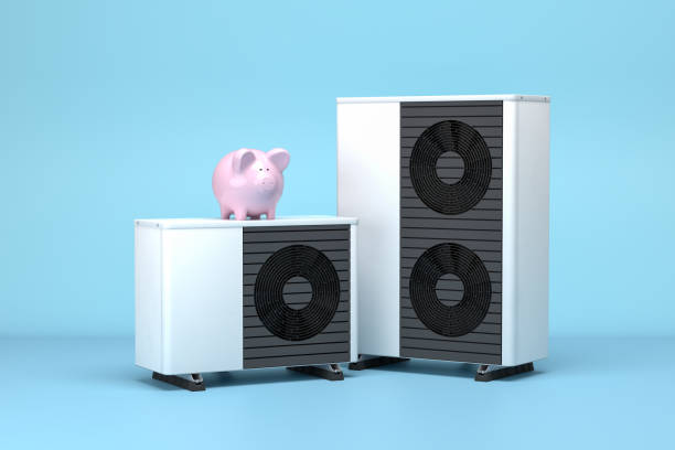 3d render of a small and large fictitious air source heat pump with a piggy bank on tip. Concept for saving energy and money by using electric air heat pumps. stock photo