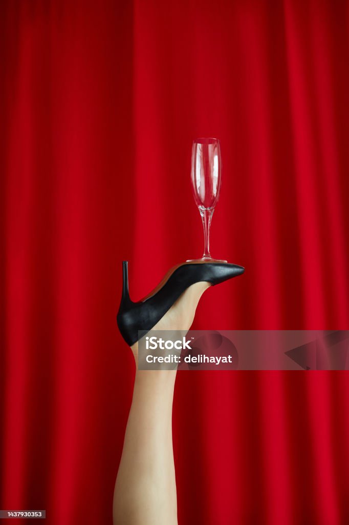 Woman Leg With Black Fancy High Heel Shoes And Fancy Champagne
