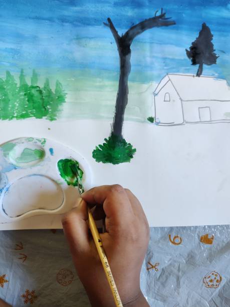 istock A child is painting in a paper. 1437930541