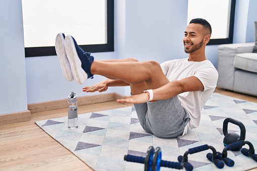 African american man smiling confident training abs exercise at home