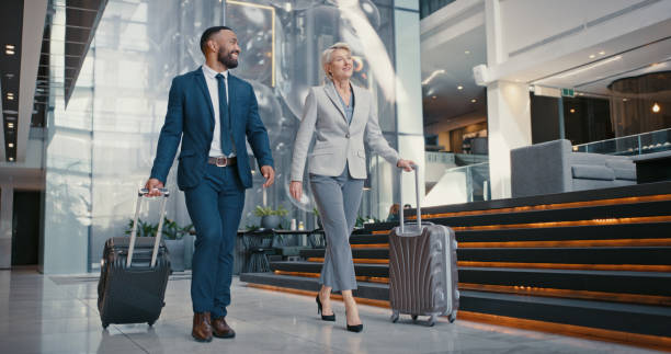 Travel, suitcase or business people in airport for conference, vacation or international work trip with manager. Employees, workers or corporate woman and man walking to airplane, hotel or workshop. stock photo