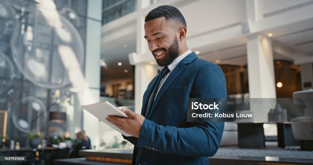 Businessman, digital tablet or strategy planning in hotel conference lobby or airport travel lounge. Happy smile, corporate worker or technology app to budget company finance or schedule target goals Finance Stock Photo