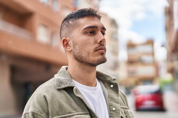 istock Young hispanic man with relaxed expression standing at street 1437931735