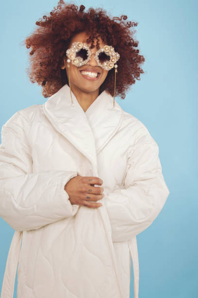 Happy young woman wrapped in a winter jacket