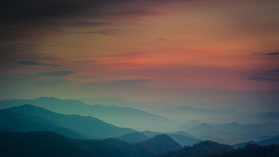 A majestic shot of impressive layered mountain range in Great Smoky Mountains National Park at colorful sunset