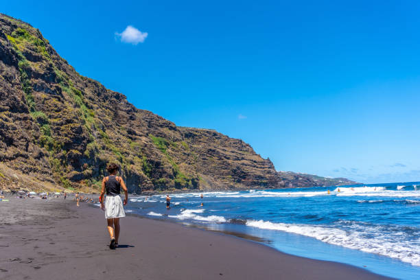Female tourist on the beach of Nogales in the east of the Island of La Palma, Canary Islands. Spain A female tourist on the beach of Nogales in the east of the Island of La Palma, Canary Islands. Spain nogales arizona stock pictures, royalty-free photos & images