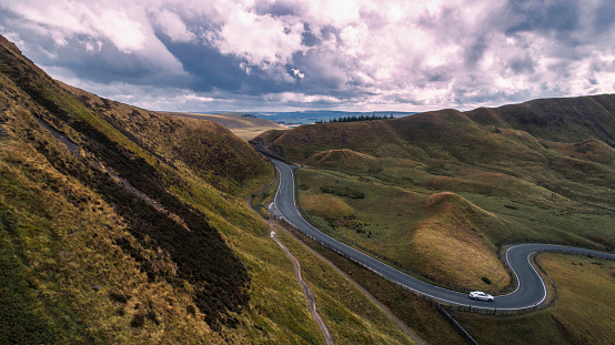 This is the shot of Edale valley twisty road at sunset using drone from Mam Tor. English Peak District national park Derbyshire, England, UK