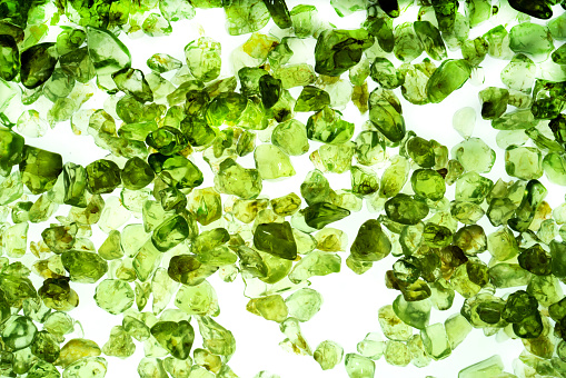 A set of green quartz crystals on a white background