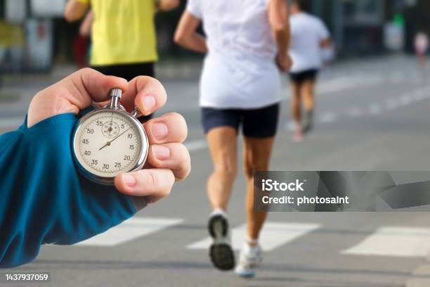 Measuring The Running Speed Of An Athlete Using A Mechanical Stopwatch Hand  With A Stopwatch On The Background Of The Legs Of A Runner Stock Photo -  Download Image Now - iStock