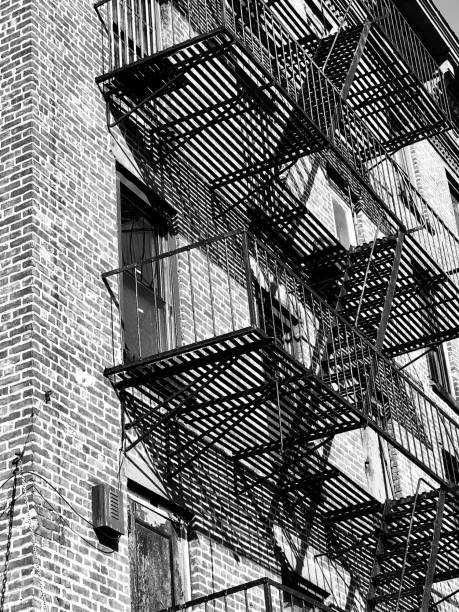 istock Vertical low angle greyscale of a building with stairs outside 1437938327