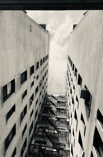 istock Vertical low angle greyscale of a building with stairs outside 1437938351
