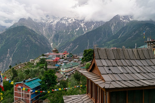 A beautiful shot of the Kalpa village with colorful buildings and mountains in the background in the Sutlej river valley, India