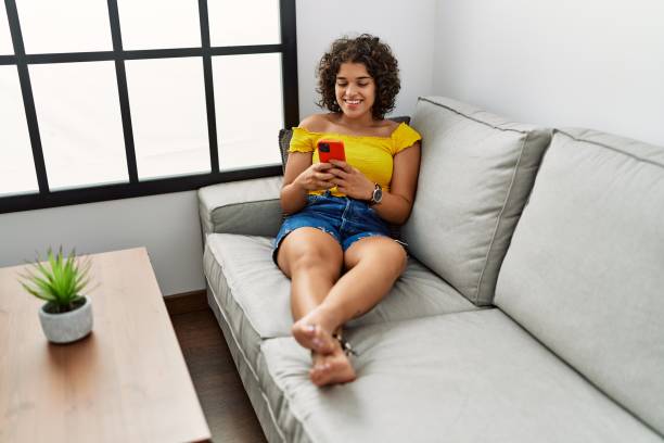 istock Young hispanic woman smiling confident using smartphone at home 1437938669