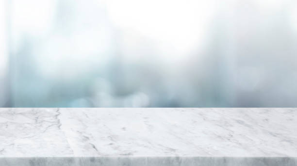 istock Selective focus.Marble table top on blur abstract window glass background. 1437938955