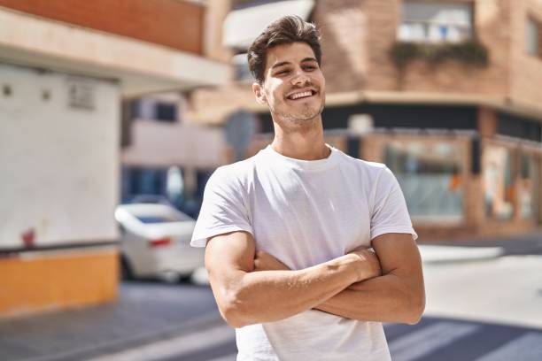 istock Young hispanic man standing with arms crossed gesture at park 1437941152