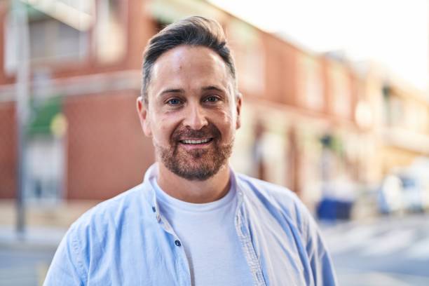 istock Young caucasian man smiling confident standing at street 1437941605