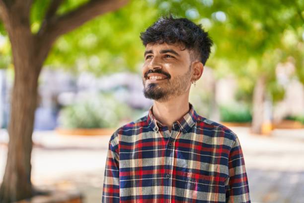 istock Young hispanic man smiling confident looking to the side at park 1437941880