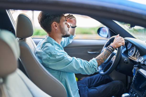 istock Young hispanic man stressed driving car at street 1437941945