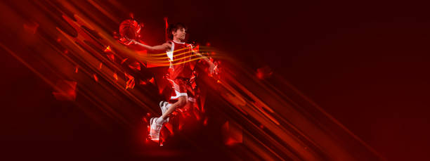 istock Creative artwork. Teen boy, basketball player training over red background with polygonal and fluid neon elements. Champion 1437943031