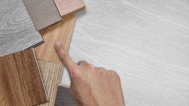 istock close up of interior architect's hand choosing flooring materials for design including various wooden type of engineering and vinyl flooring tiles for construction. 1437943734
