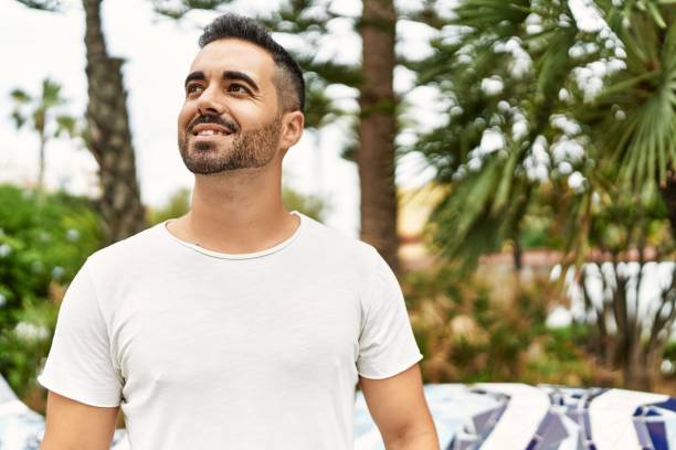 istock Young hispanic man smiling confident walking at park 1437943819