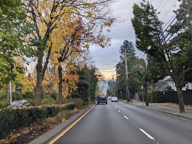 Surrey, Canada - October 29, 2022: Traffic heads southbound on 152nd Street near 84th Avenue in the Fleetwood neighbourhood. Autumn morning with overcast skies in Metro Vancouver.