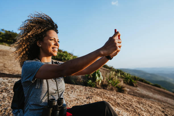 istock Backpacker woman in the mountain using smartphone 1437946716