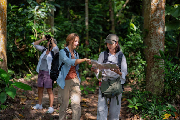 istock Backpack tourist travel outdoor adventure bird study using binoculars looking and record to book 1437947236