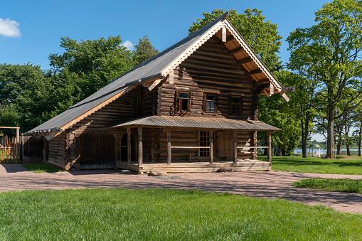 Veliky Novgorod, Russia, July 31, 2022: View of the log house in the Novgorod Museum of Folk Wooden Architecture of Vitoslavlitsa on a sunny summer day