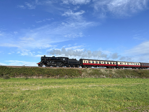 A steam train travelling through open countryside