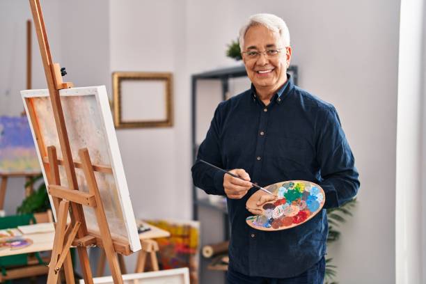 istock Senior man smiling confident drawing at art studio 1437952532