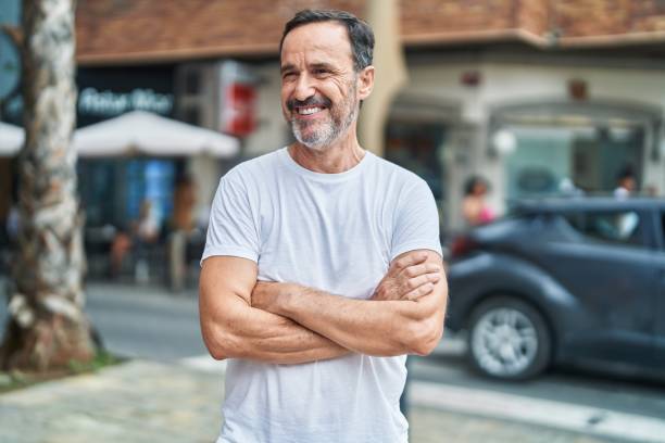 istock Middle age man standing with arms crossed gesture at street 1437953143