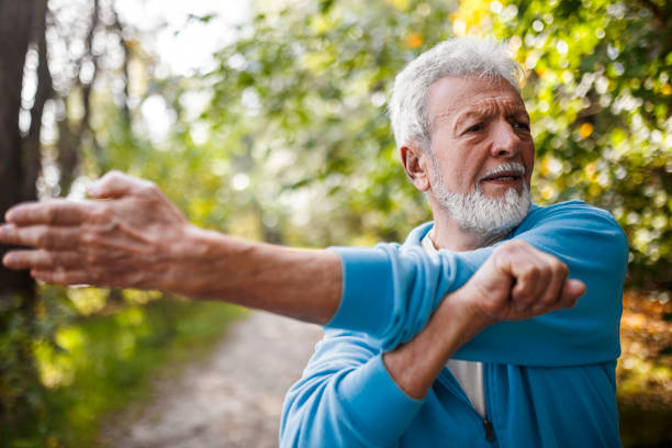 istock Senior runner stretching in the public park 1437955689