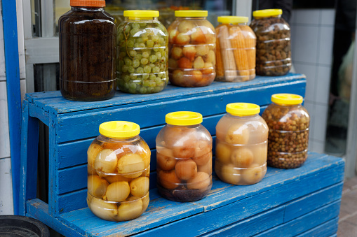 Various Canned Pickles in glass jars on the counter
