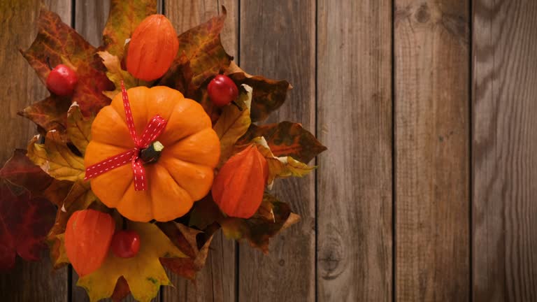 Colorful autumn leaves on rustic wooden background with copy space