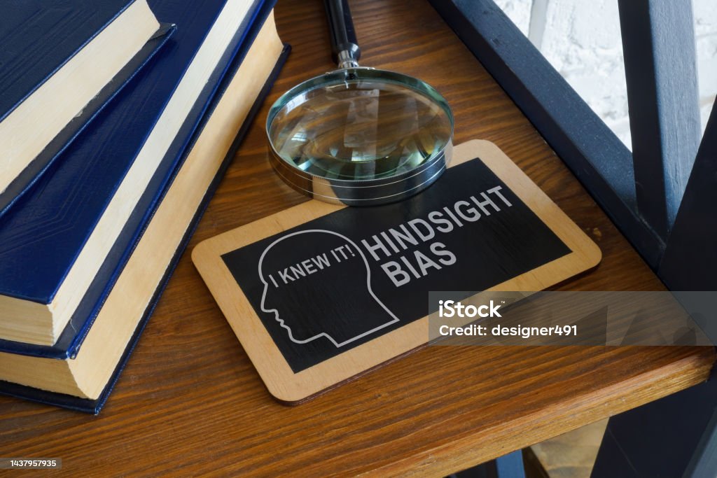 Hindsight bias inscription on the plate and magnifying glass. Hindsight bias inscription on the plate and a magnifying glass. Contemplation Stock Photo