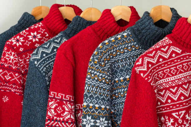 Collection of knitted Christmas turtleneck sweaters on hanger rack stock photo