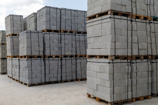 A pile of new bricks at construction site sitting on wooden flat. We have other construction images in our portfolio.