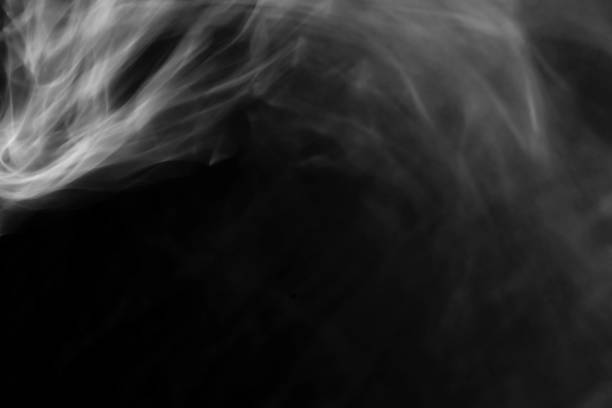 istock Beautiful white abstract steam from tea or coffee hot water  on a black isolated background Smoke pollution, cloud, cigarette, gas, dry ice ghost concept. 1437962996