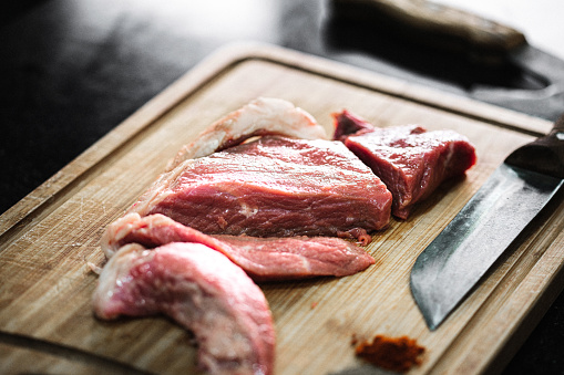 Fresh beef meat slices on cutting board