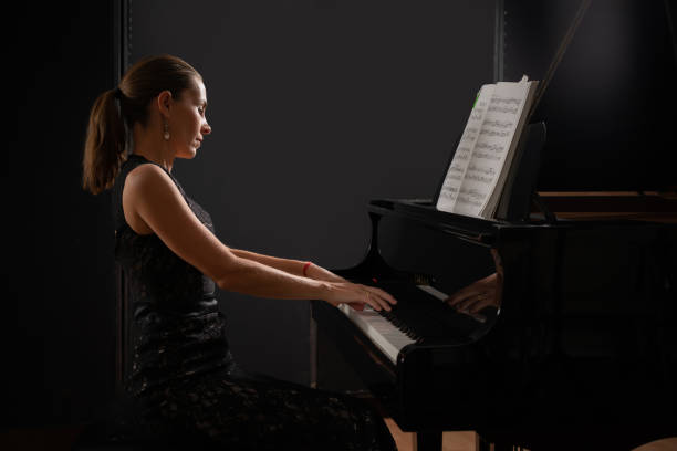 piano de cola de instrumento musical con intérprete femenina. - pianist grand piano piano playing fotografías e imágenes de stock