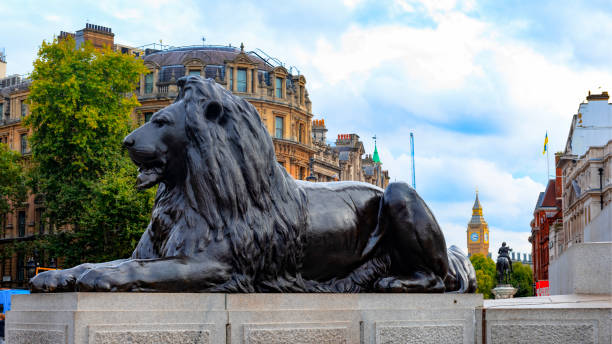 istock Big Ben clock tower behind a statue of a lion 1437971986