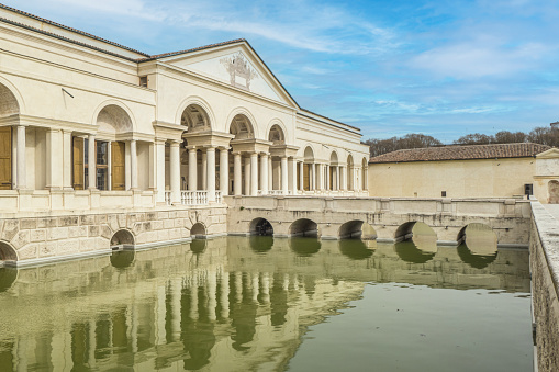 Mantua, Italy - 02-27-2022:  The beautiful facade of the famous Palazzo Te in Mantua reflecting on the water