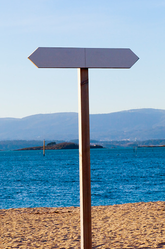 Trail sign post on Compostela beach sand,  Vilagarcía de Arousa, Rías Baixas, Pontevedra province,Galicia, Spain.
