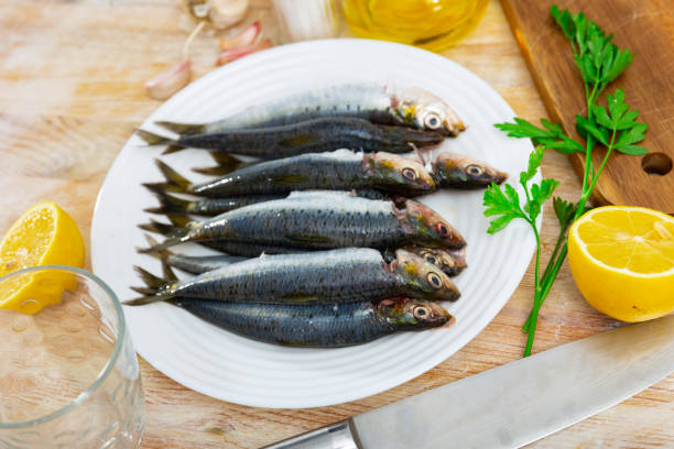 istock Fresh sardines on plate with lemon,  fish dish 1437973433