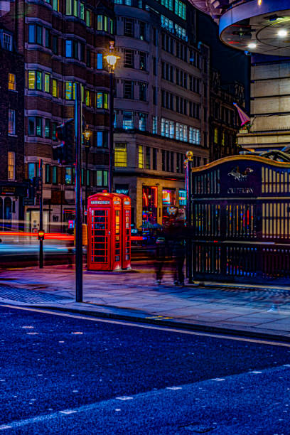 istock Red telephone booth at night 1437973523