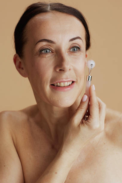 istock modern woman with roller massager on beige background 1437973786